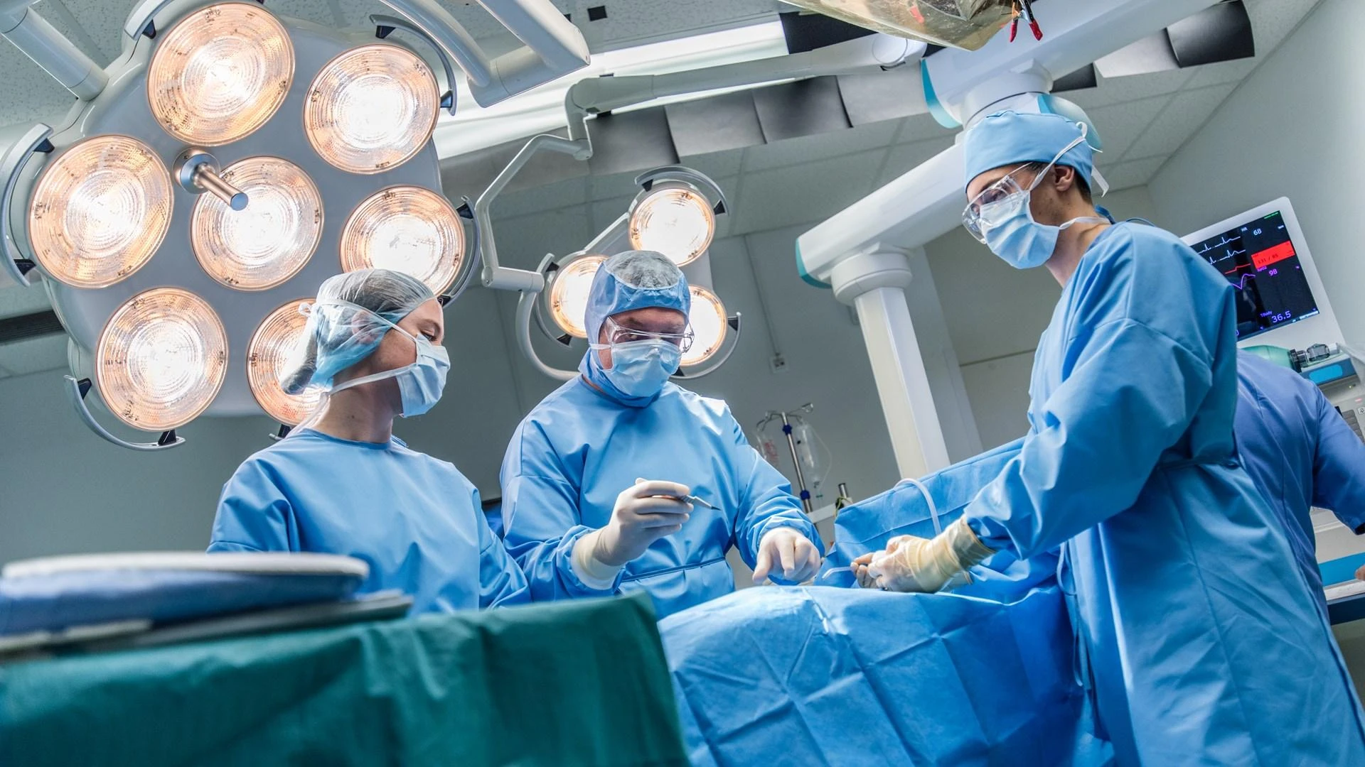 How do surgeons minimize infection risk during procedures?