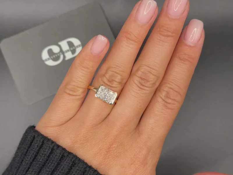 Bold Elegance with Modern Poise: The 3 Carat Radiant East-West Half-Bezel Solitaire