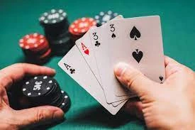Premium Photo | Playing poker in the casino. Cards with two pairs in the hand of the player making a bet with chips