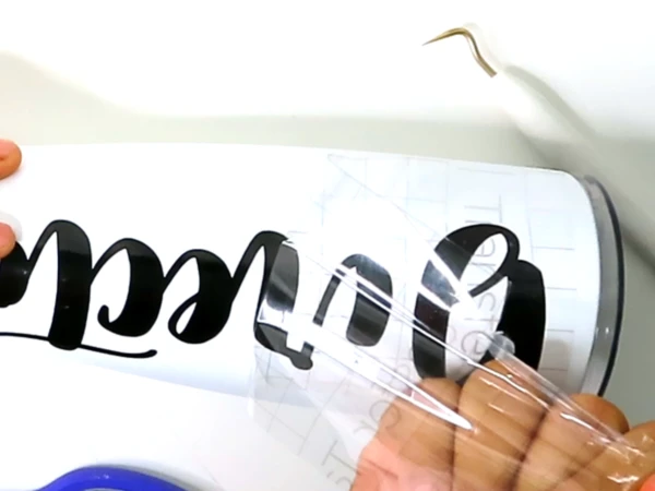 Peel off the transfer tape from the tumbler and stick it to the tumbler