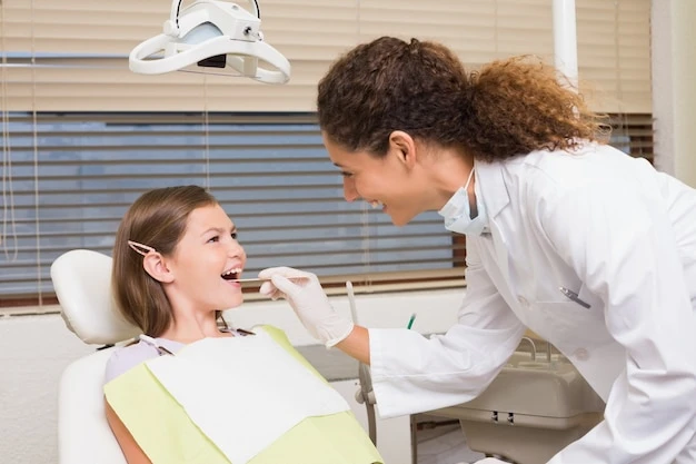Pediatric dentist examining little girls teeth in the dentists chair
