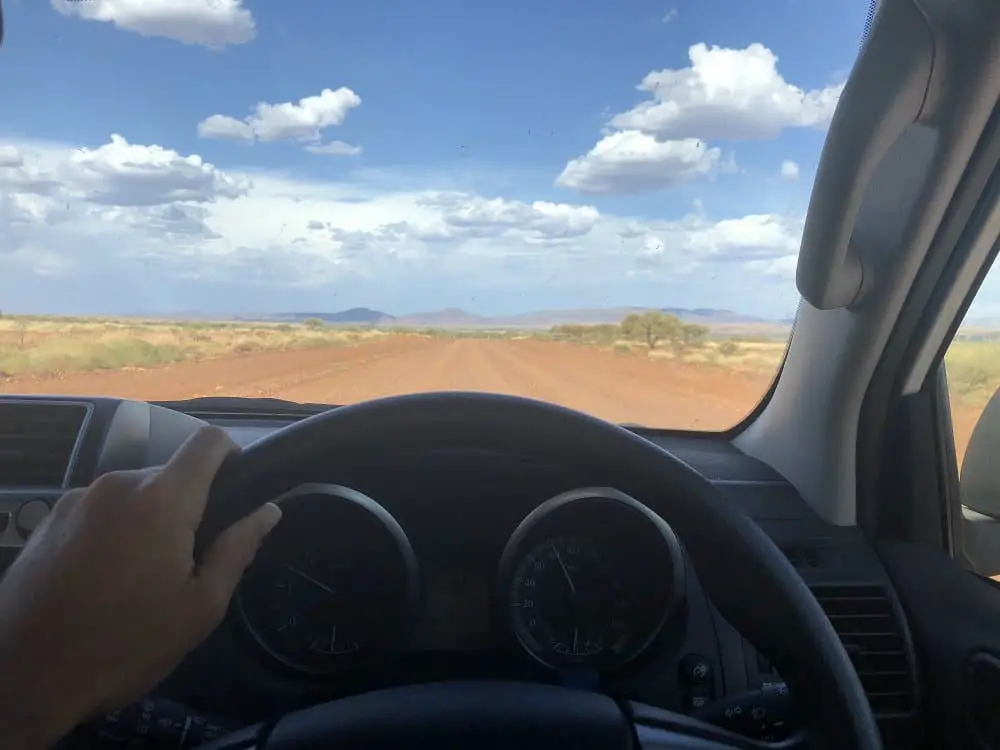 youg-millenial-driving-a-car-on-a-dirt-road-in-aus-WR2R3QN