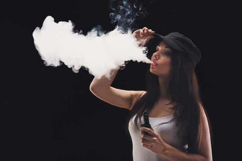 young-woman-cloud-vape-smoke-black-background-hipster-girl-cap-blowing-nicotine-free-smoking-vapor-concept-copy-100496304-transformed