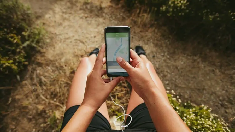 close-up-shot-woman-runner-using-fitness-app-her-smartphone-female-checking-summary-her-run-mobile-phone-pov-shot-with-focus-cellphone-hands_570631-1860