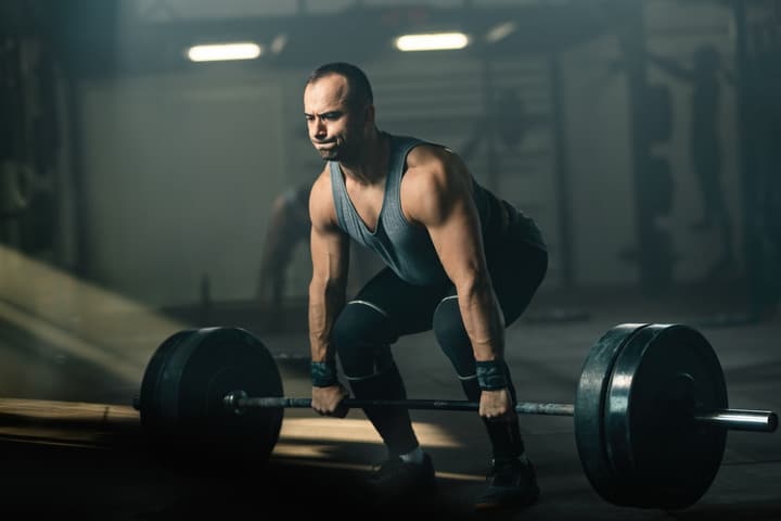 muscular-build-man-making-effort-while-weightlifting-during-cross-training-gym-3