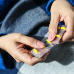 Person popping a pill