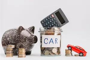 Screenshot 2023-09-19 at 13-24-27 Premium Photo Calculator on glass coins jar with coin stack car and piggybank against white background