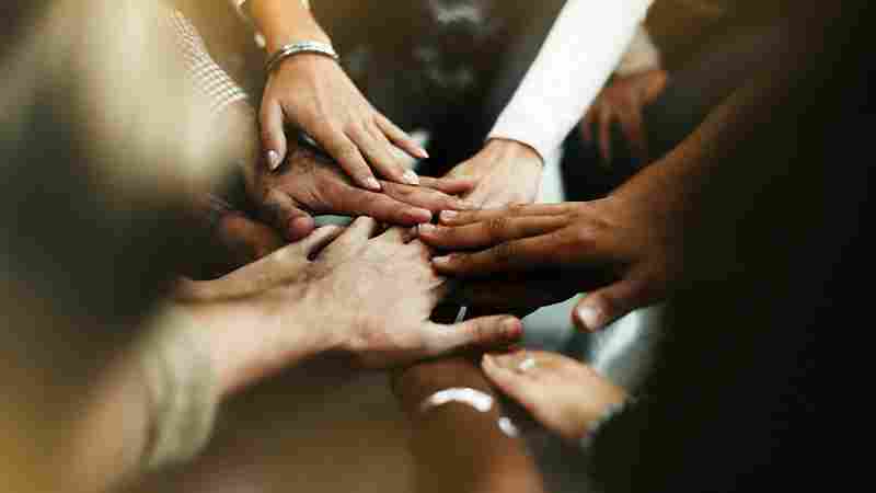 closeup-diverse-people-joining-their-hands_11zon