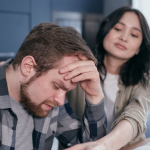 Woman looking at a stressed man