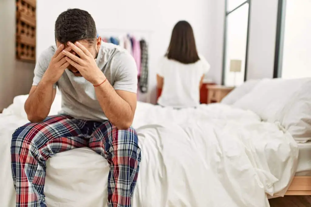 young-latin-couple-trouble-sitting-bed-with-hands-head-1024x683