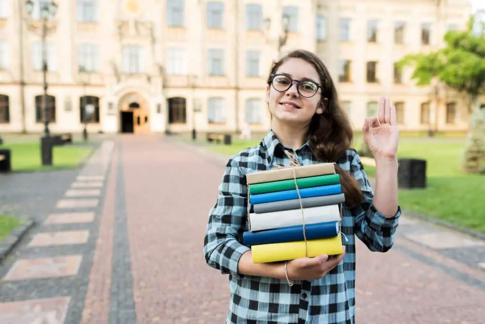 medium-shot-highschool-girl-holding-books-hands1