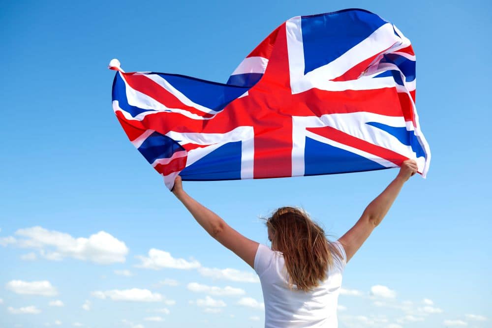 rear-view-young-woman-waving-british-flag1