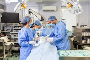 team-professional-doctors-performing-operation-surgery-room-medical-team-performing-surgical-operation-bright-modern-operating-room_657921-1123 (1)