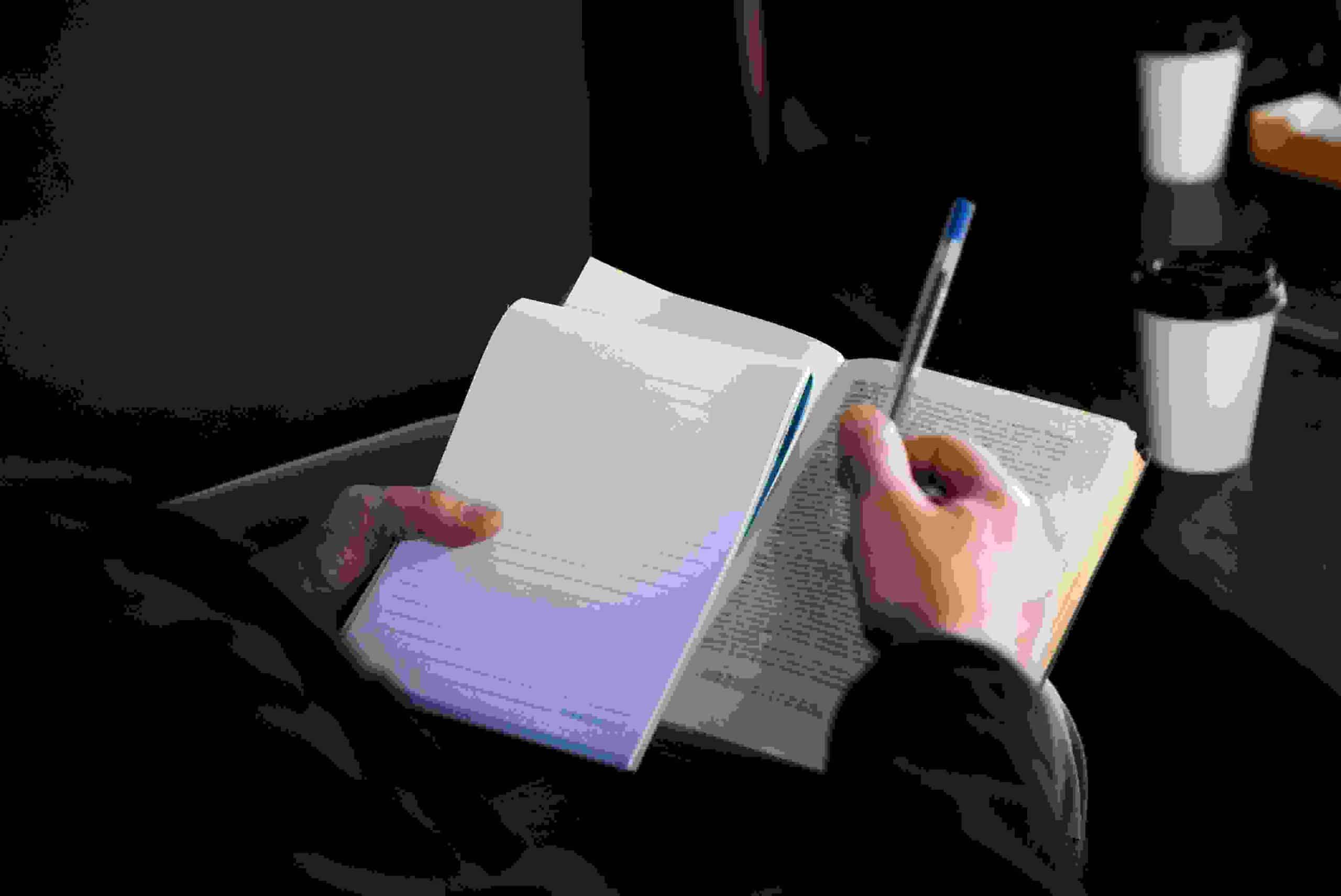 high-angle-hand-holding-notebook-compressed-compressed