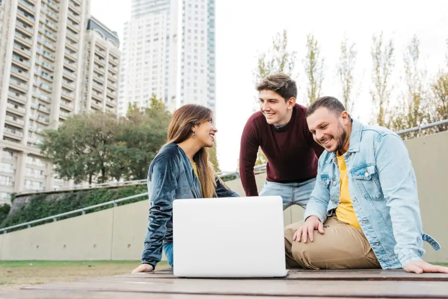 young-freelance-students-working-laptop-outside1