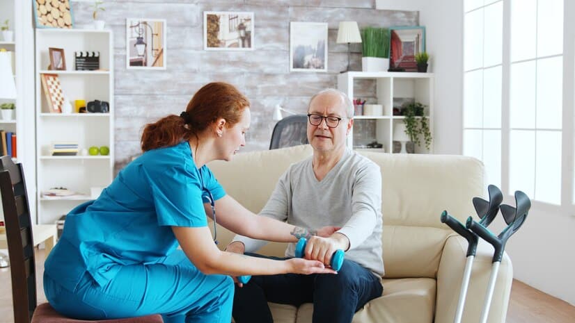 female-nurse-helps-old-man-make-his-morning-exercises-bright-cozy-retirement-home_482257-20744