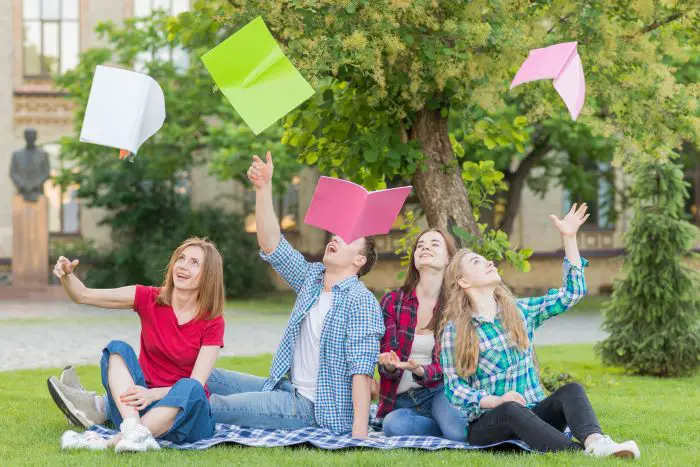 group-students-throwing-books-air1