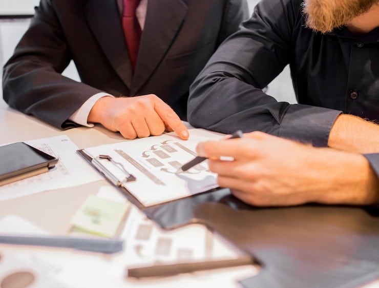 close-up-two-businessmen-pointin