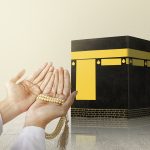 Muslim man praying with prayer beads on his hands in front of the Kaaba